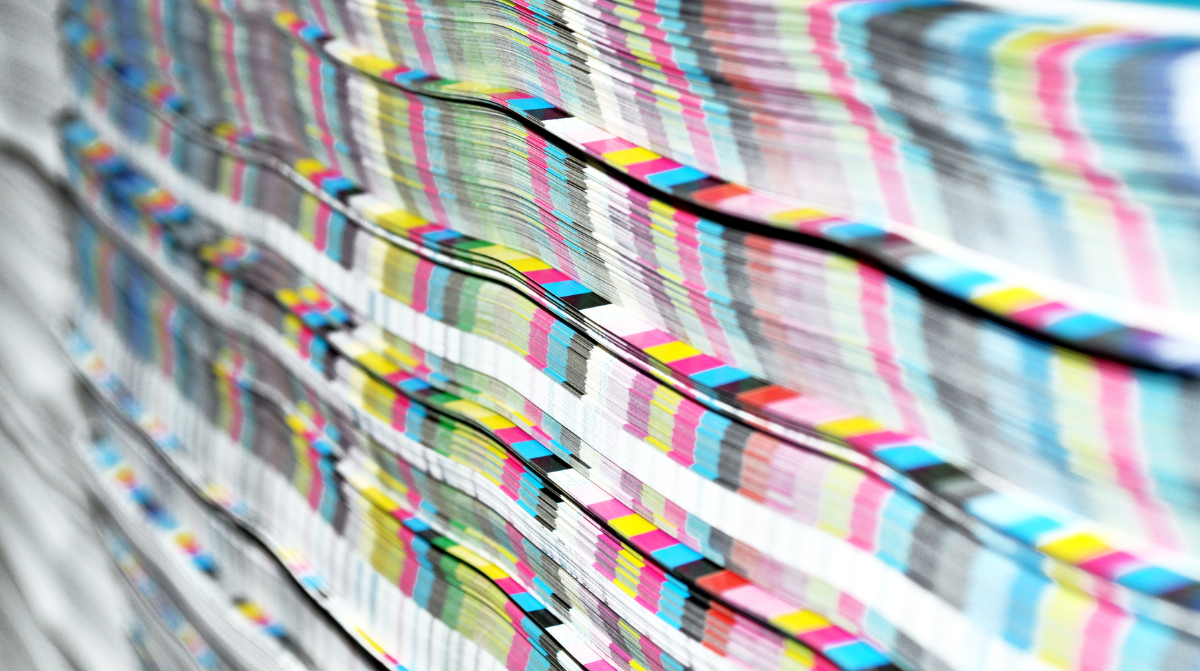 Stack of paper with CMYK scale